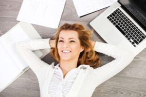 istock woman on floor with desktop and papers